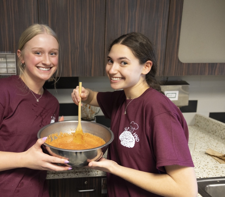 Two female student cooking