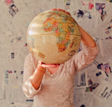 Student holding a globe