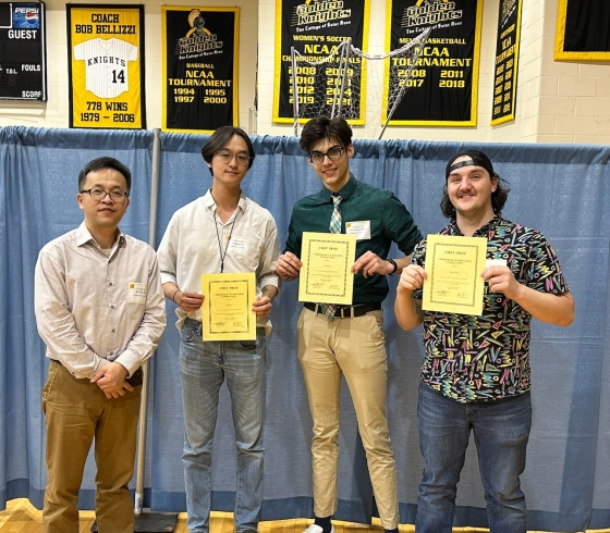 Male professor with three male students at academic conference