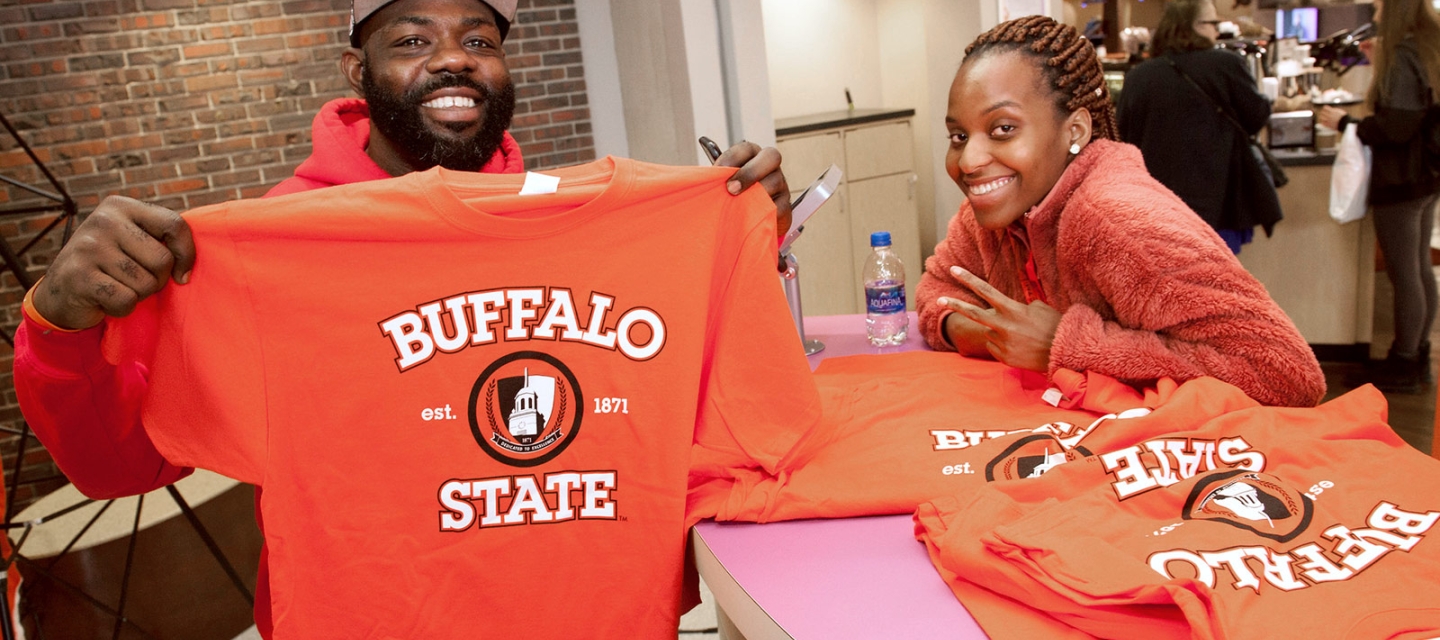 Students posing with T-shirts