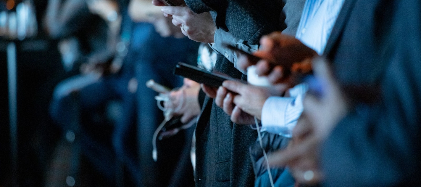 People using phones while standing